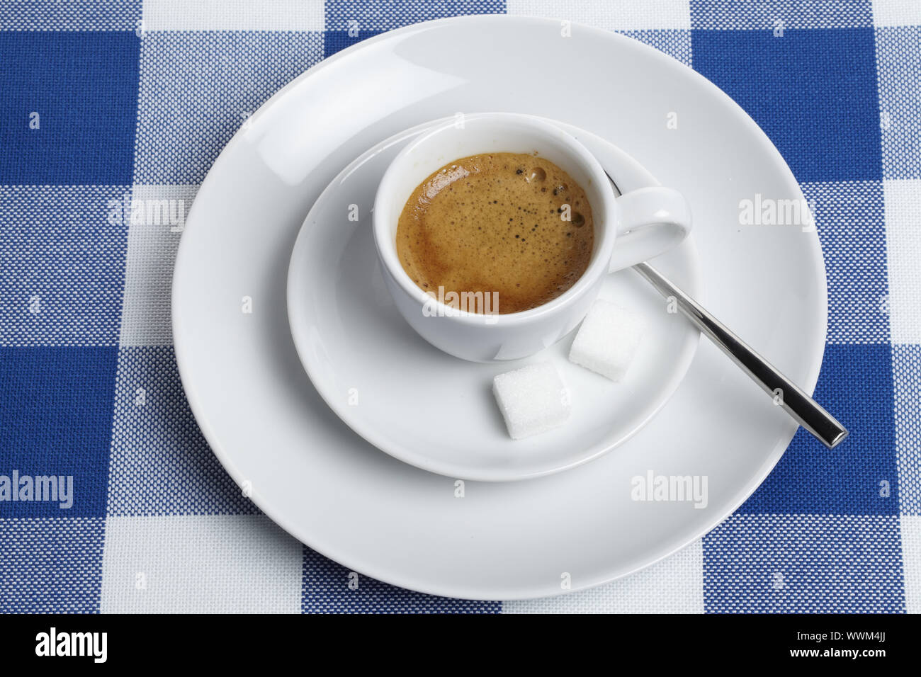 Espresso with sugar cubes on tablecloth Stock Photo - Alamy
