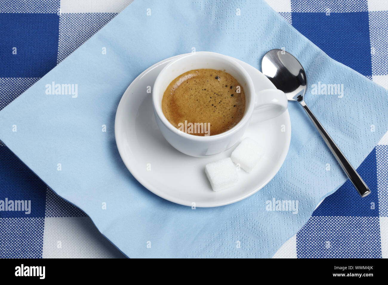 Espresso with sugar cubes on tablecloth Stock Photo - Alamy