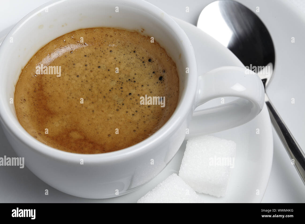 Espresso with sugar cubes and spoon Stock Photo Alamy