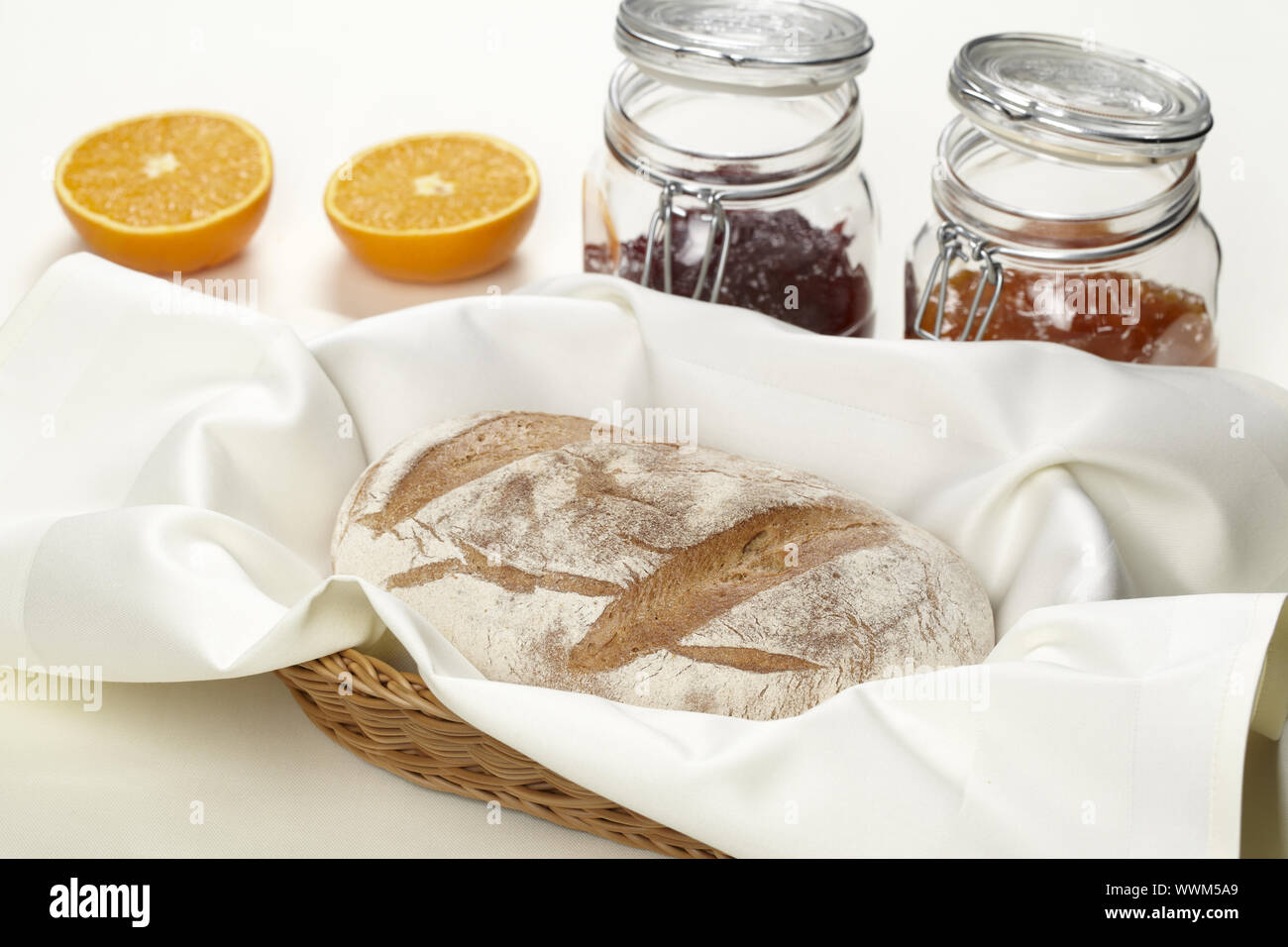 Basket with bread and jam Stock Photo - Alamy