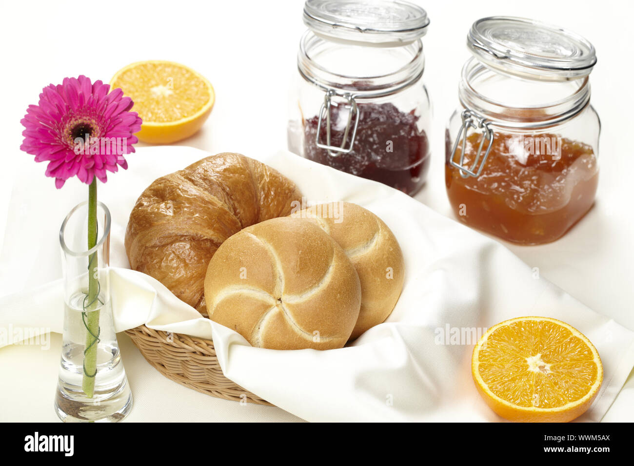 Basket with bread rolls and jam Stock Photo - Alamy