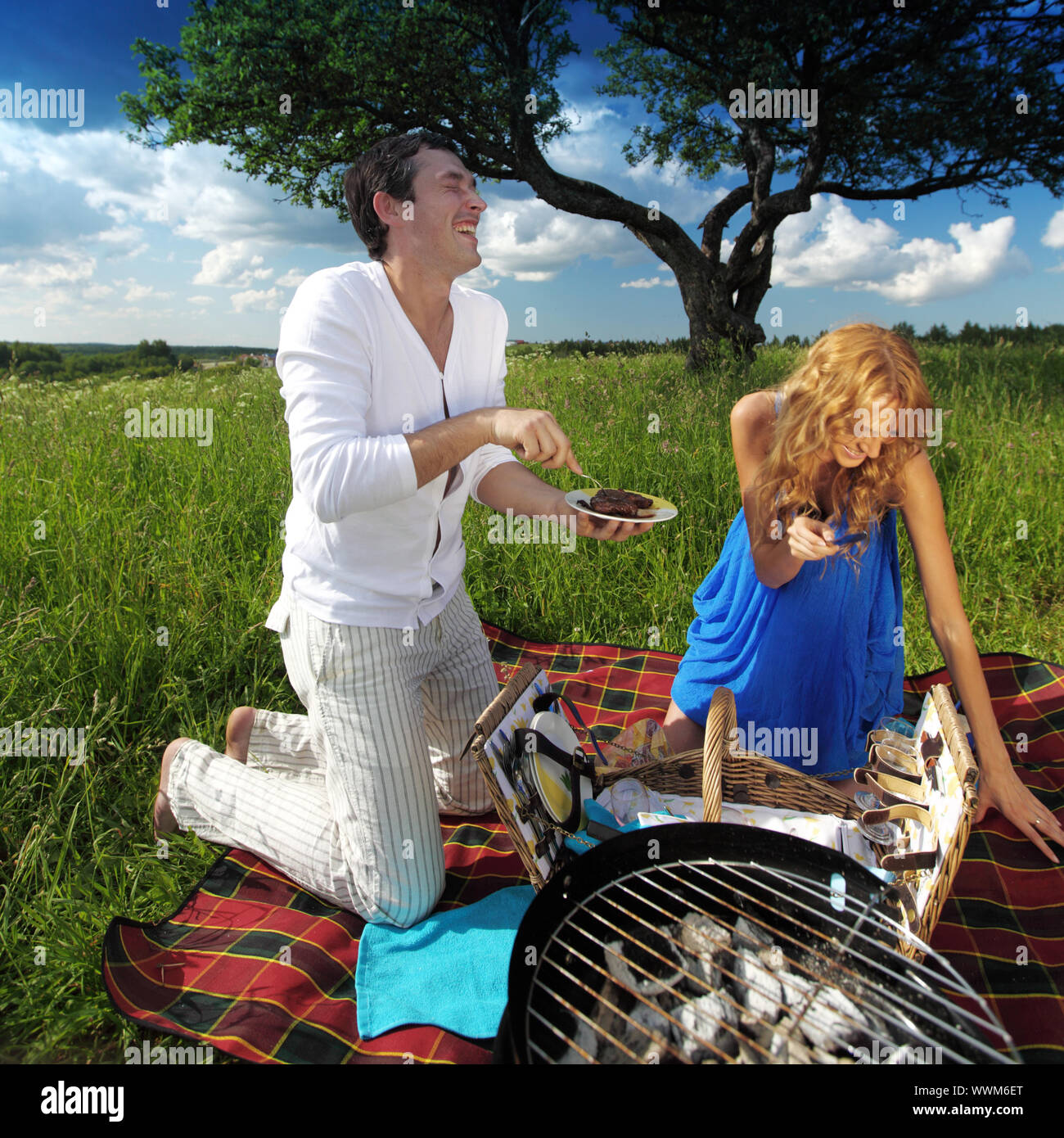 man and woman on picnic in green grass Stock Photo - Alamy