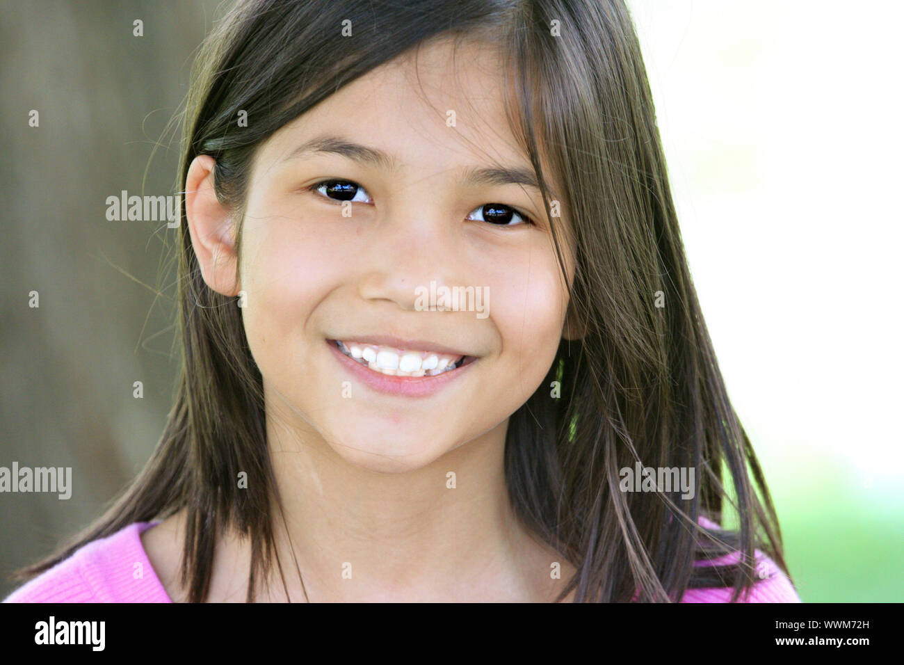 Beautiful little girl smiling outdoors Stock Photo - Alamy