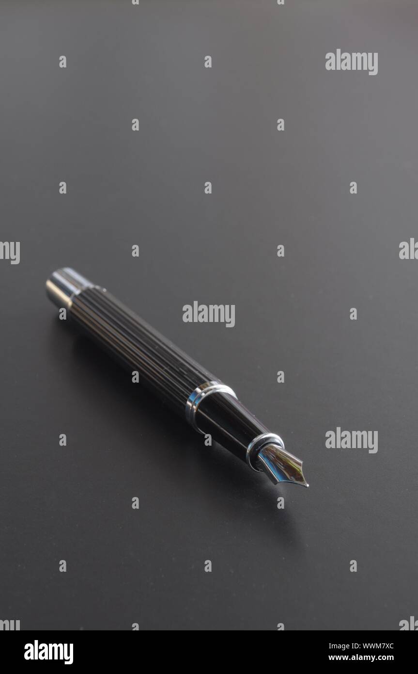 pen showing communication contact us or mail concept on black background Stock Photo