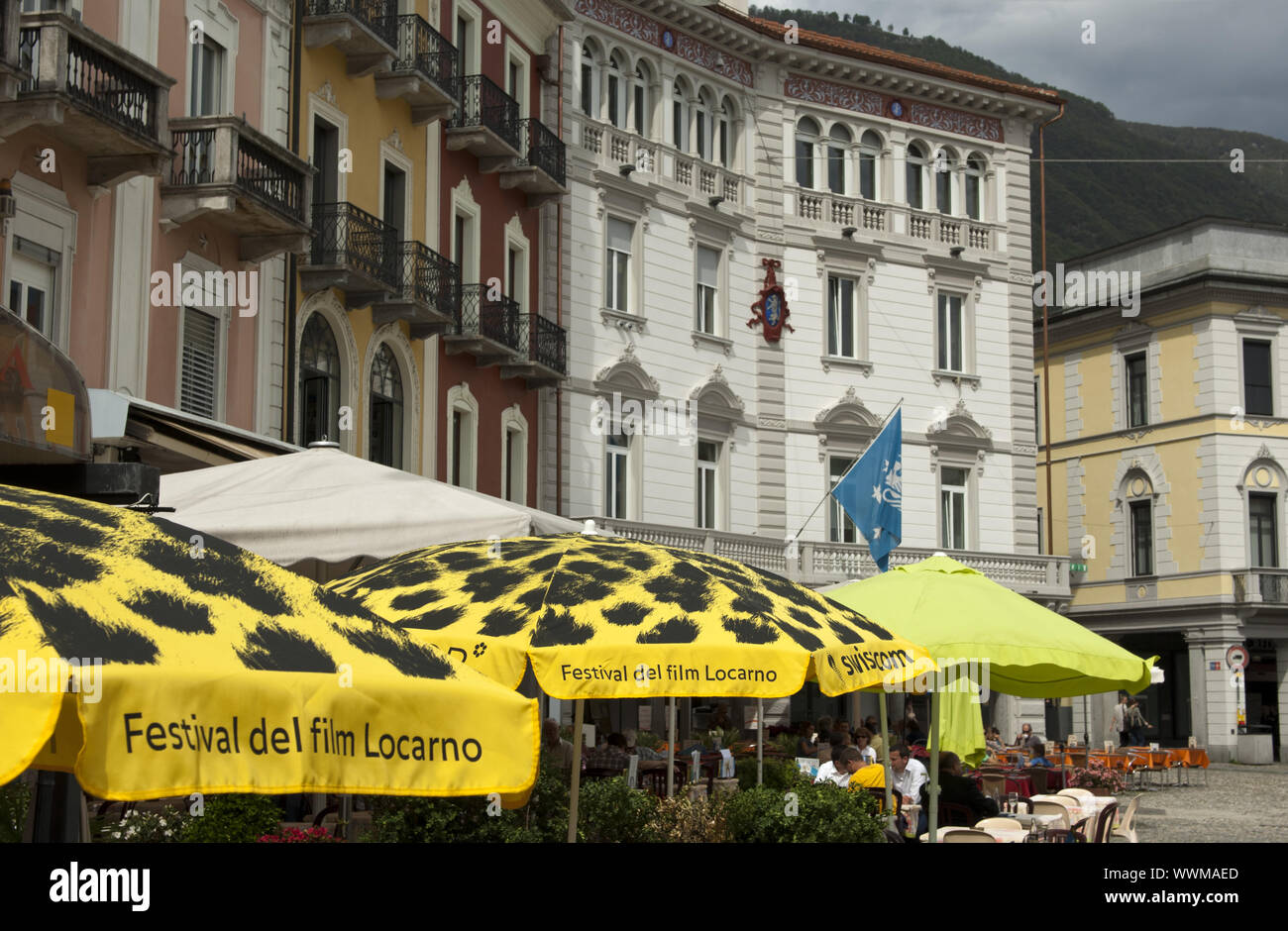 Umbrellas with advertising for the Locarno International Film Festival in a café in Piazza Grande Stock Photo