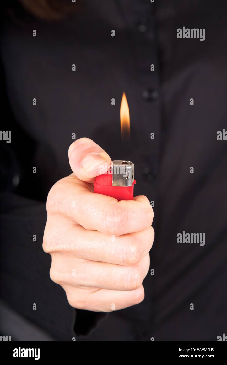 woman detail holding a red lighter in her hand Stock Photo Alamy