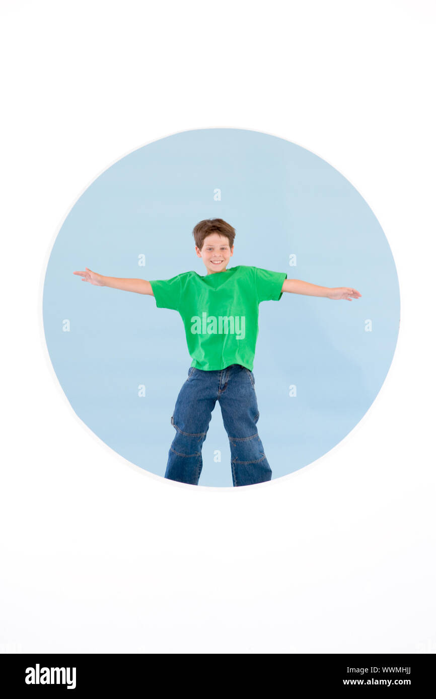 Young boy standing with arms out smiling Stock Photo