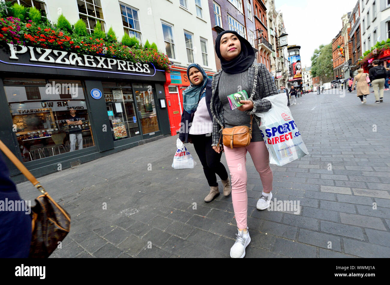 London, England, UK. Women with headscarves shopping in Chinatown Stock Photo