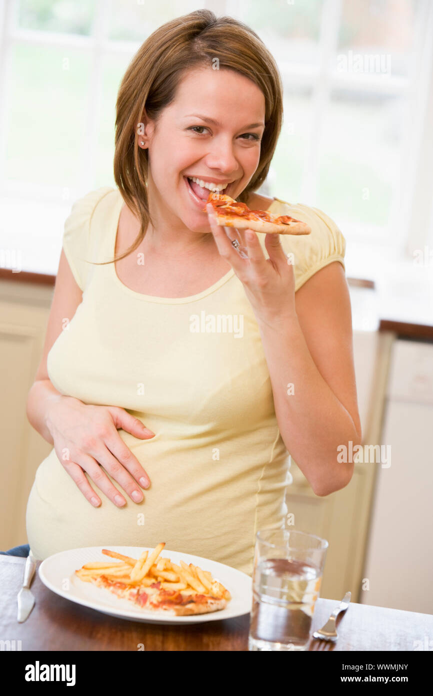 Pregnant woman eating meal chips hires stock photography and images