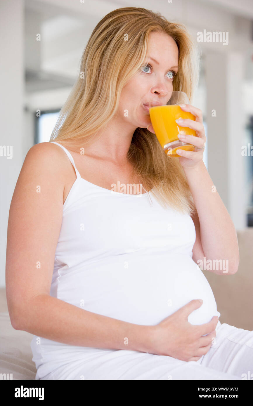 Pregnant woman with glass of orange juice Stock Photo - Alamy