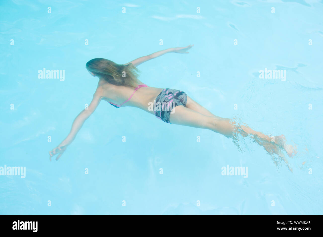 Young girl in swimming pool underwater Stock Photo