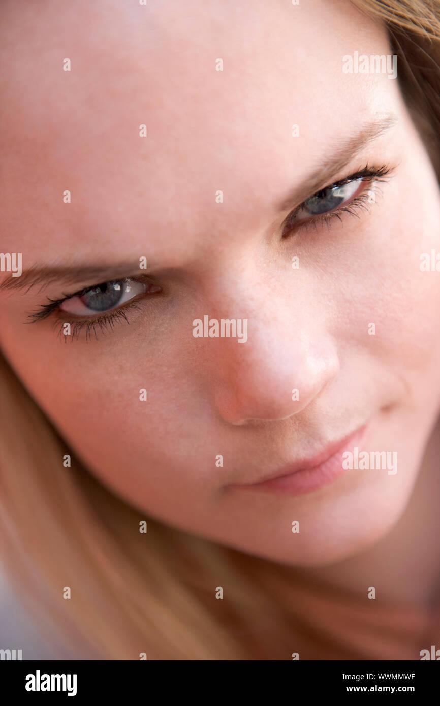 Head shot of woman scowling Stock Photo