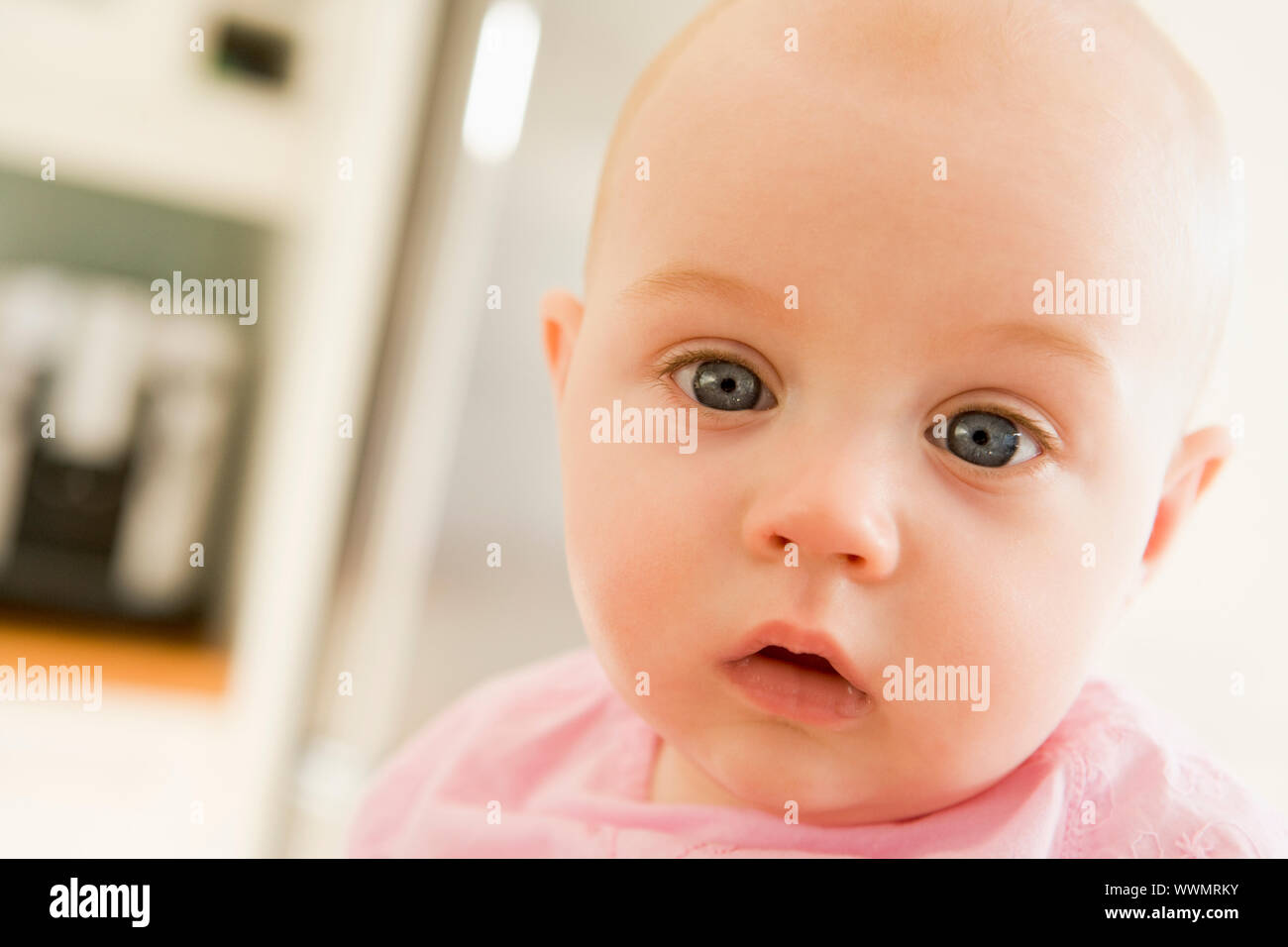 Baby's face in kitchen Stock Photo