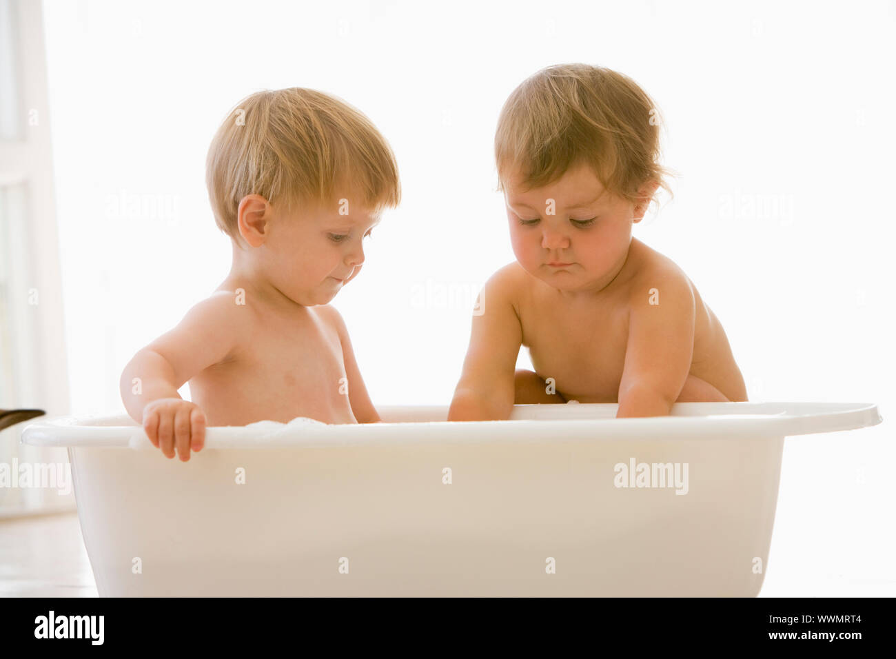 Two babies in bubble bath Stock Photo Alamy
