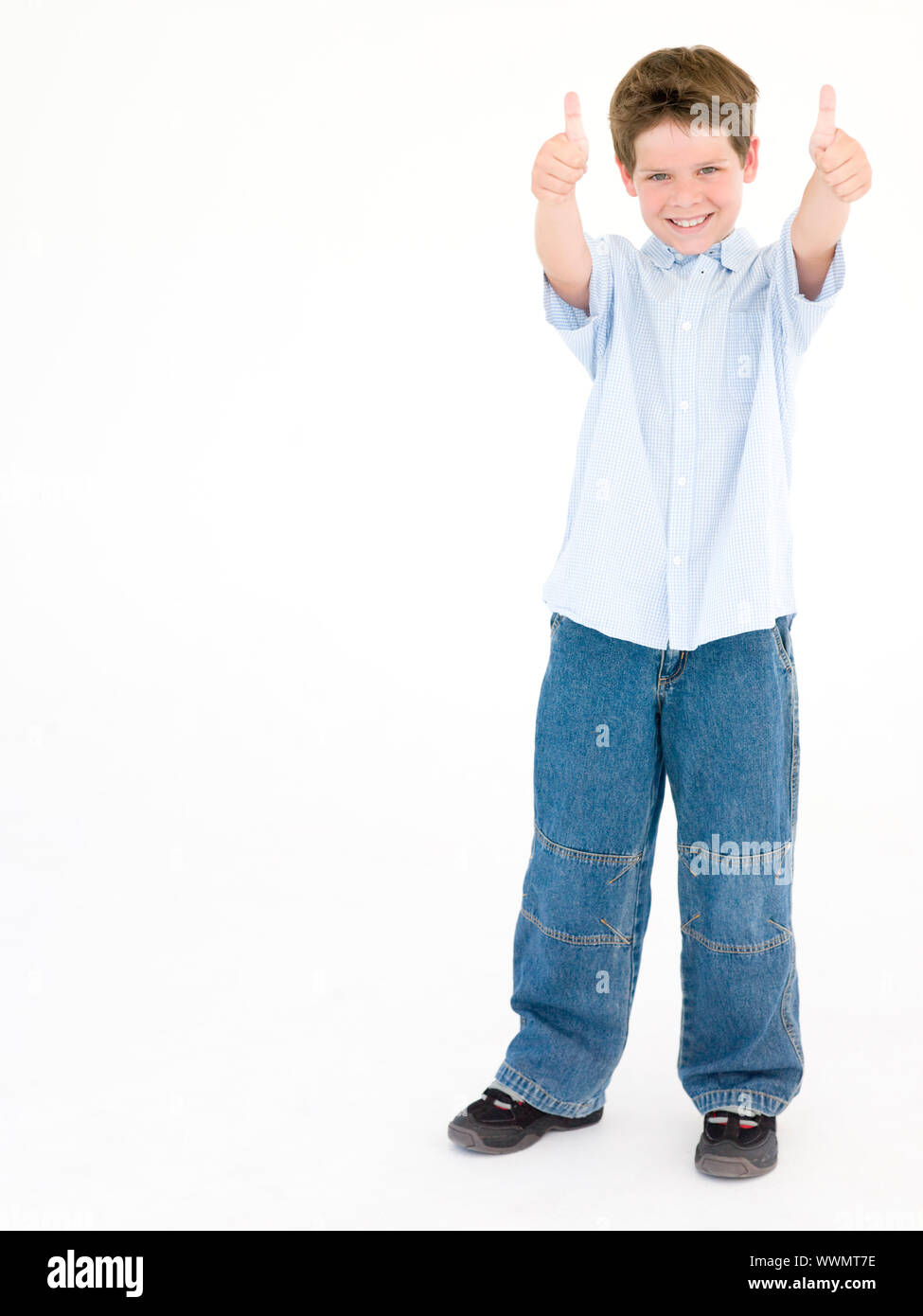 Young boy giving thumbs up smiling Stock Photo - Alamy