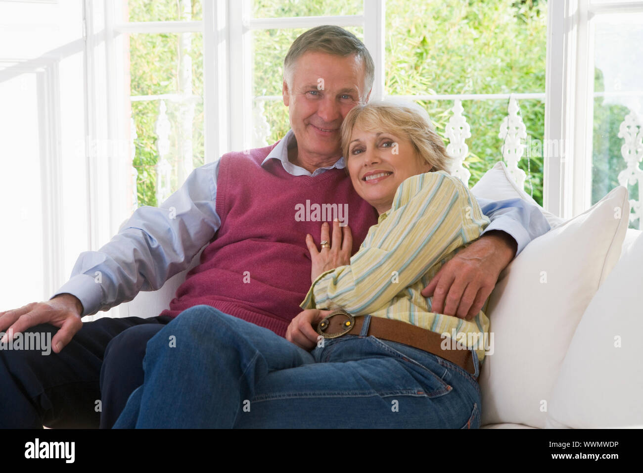 Couple in living room smiling Stock Photo