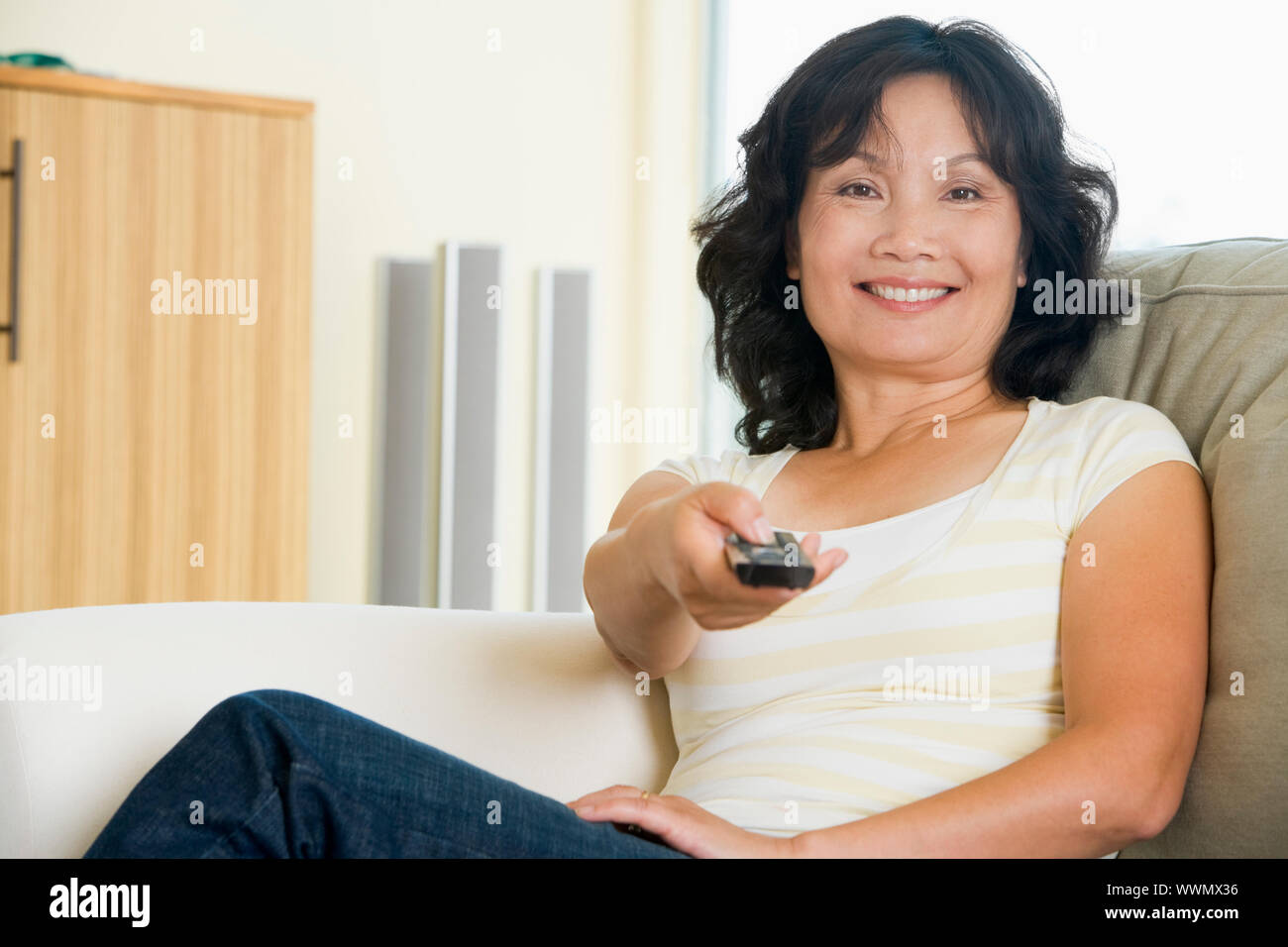 One mature woman in living tv hi-res stock photography and images - Alamy