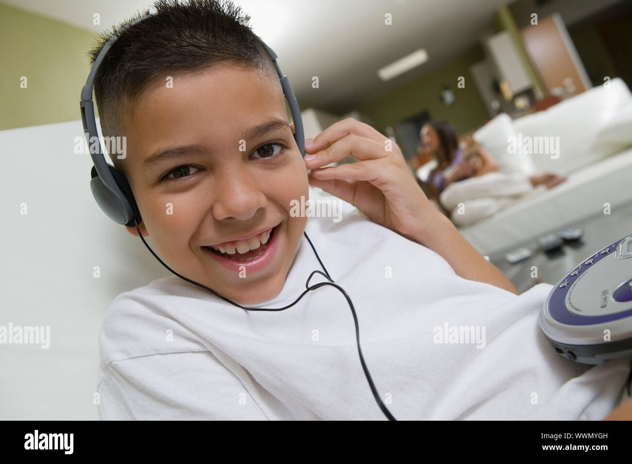 Boy Listening to Music on Portable CD Player Stock Photo - Alamy