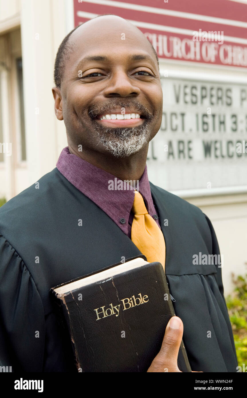 Smiling preacher bible in church hi-res stock photography and images