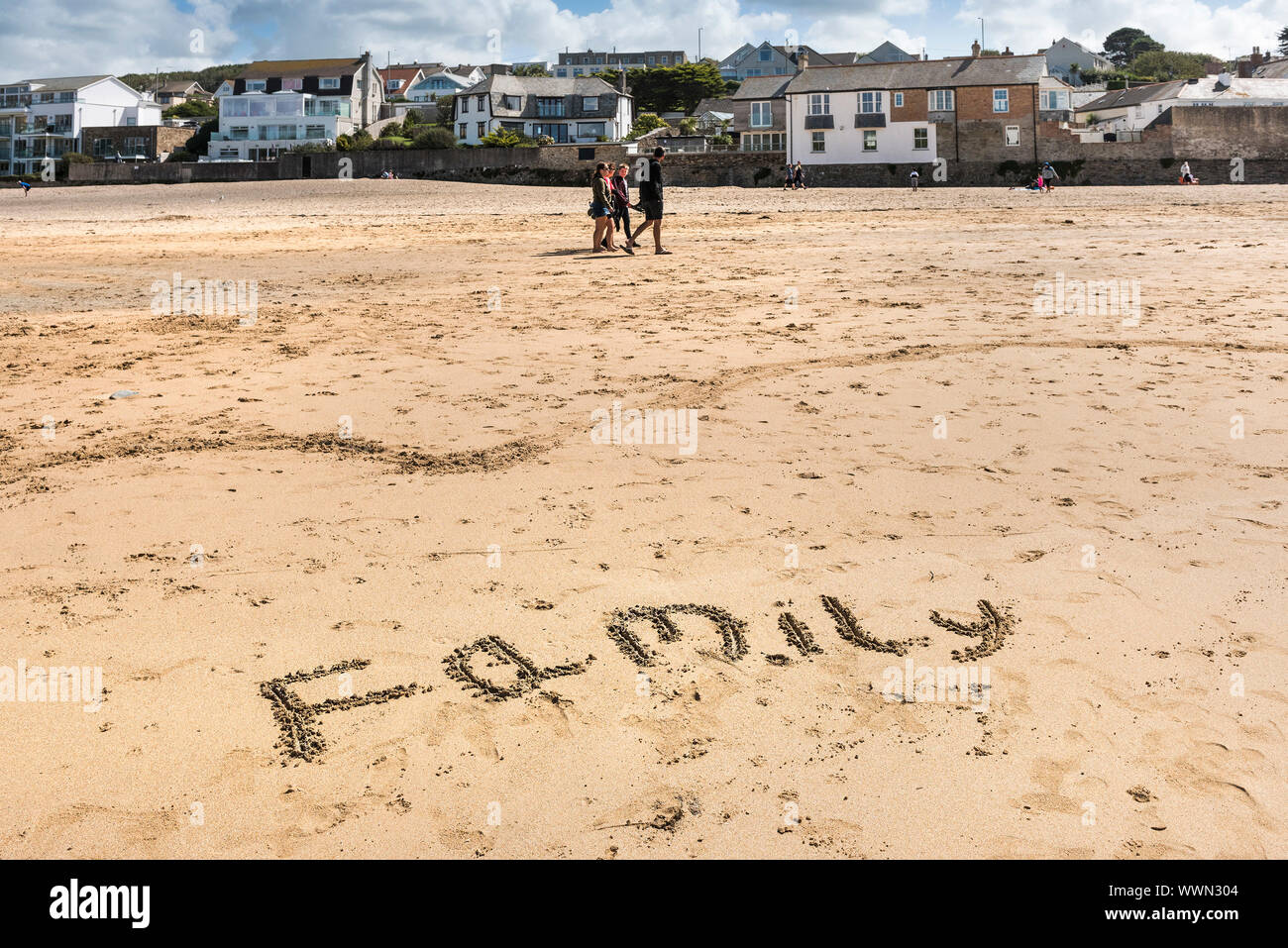 The word Family written in the sand on Porth Beach in Newquay in Cornwall. Stock Photo