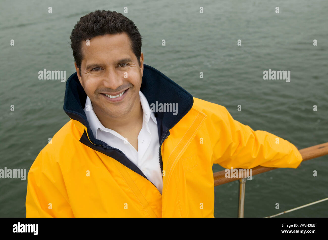 Man Holding onto Boat Railing Stock Photo - Alamy