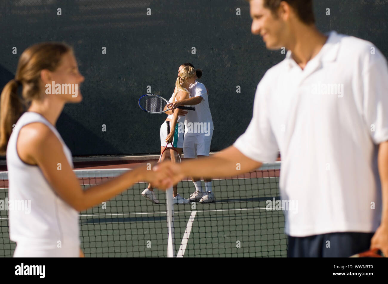 Tennis Players Shaking Hands at Net Stock Photo