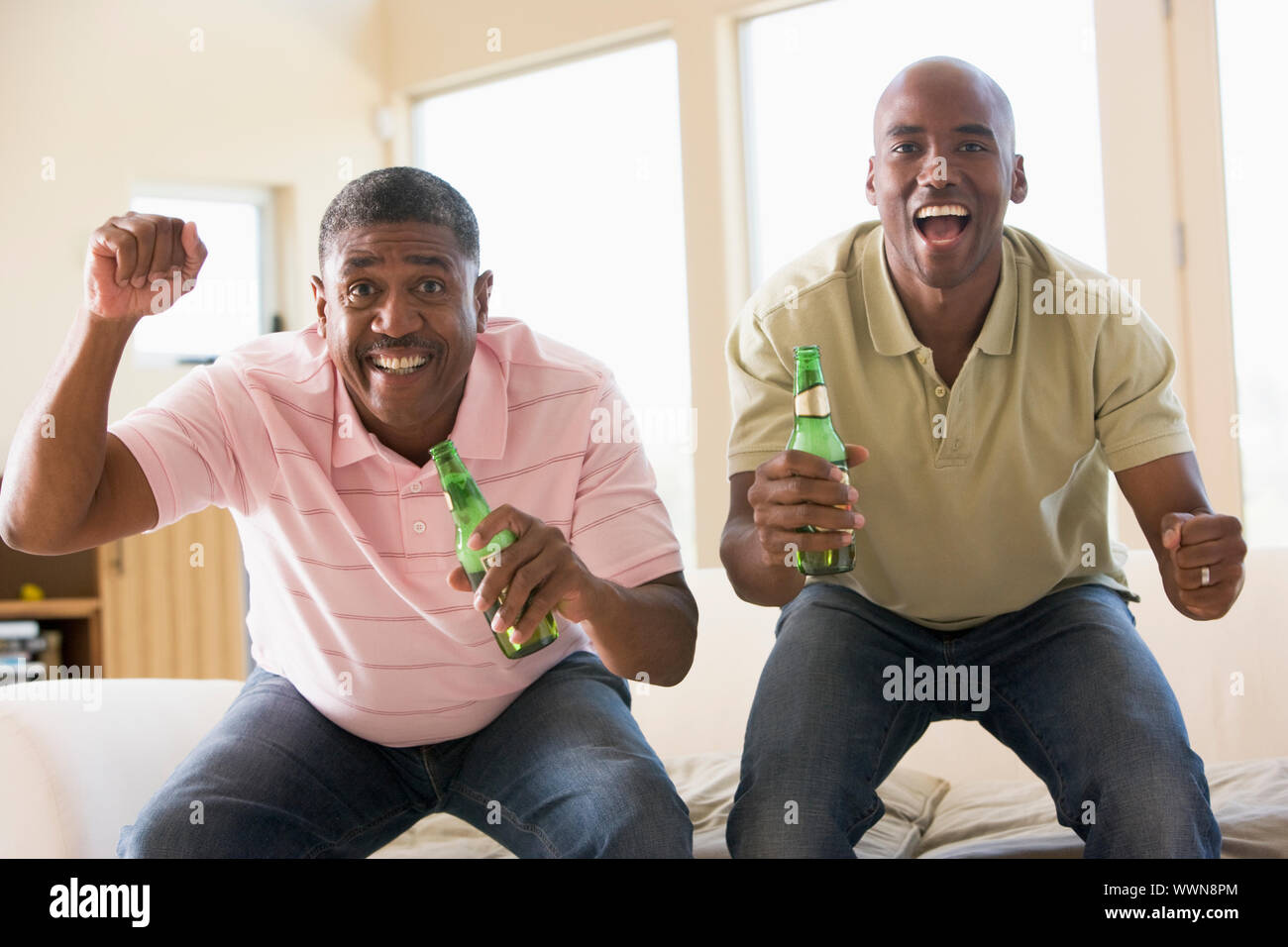 Two men holding up bottles hi-res stock photography and images - Alamy