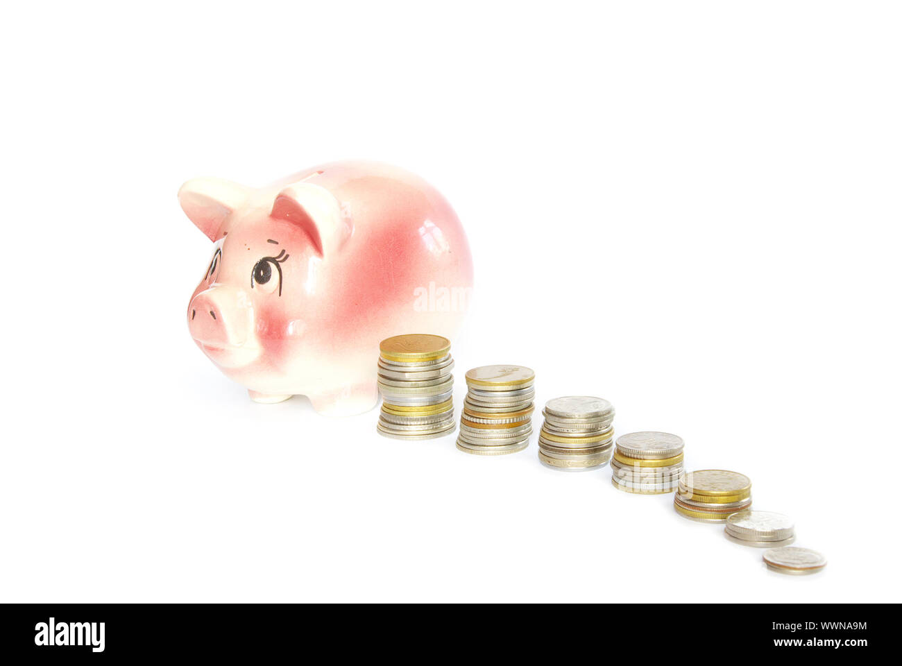 Pink piggy bank isolated on white background with coins Stock Photo - Alamy