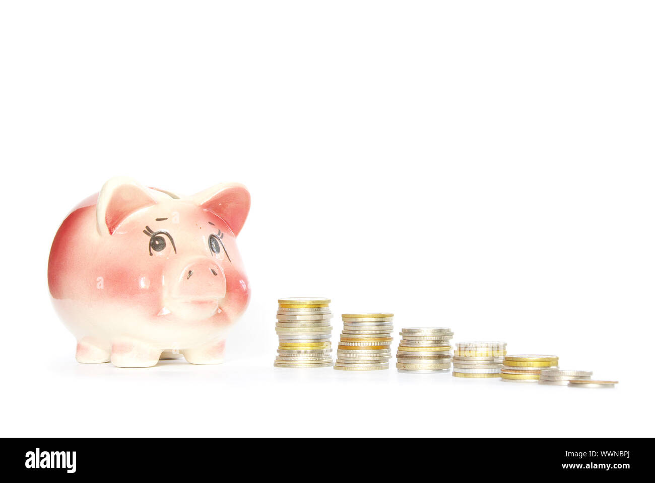 Pink piggy bank isolated on white background with coins Stock Photo - Alamy