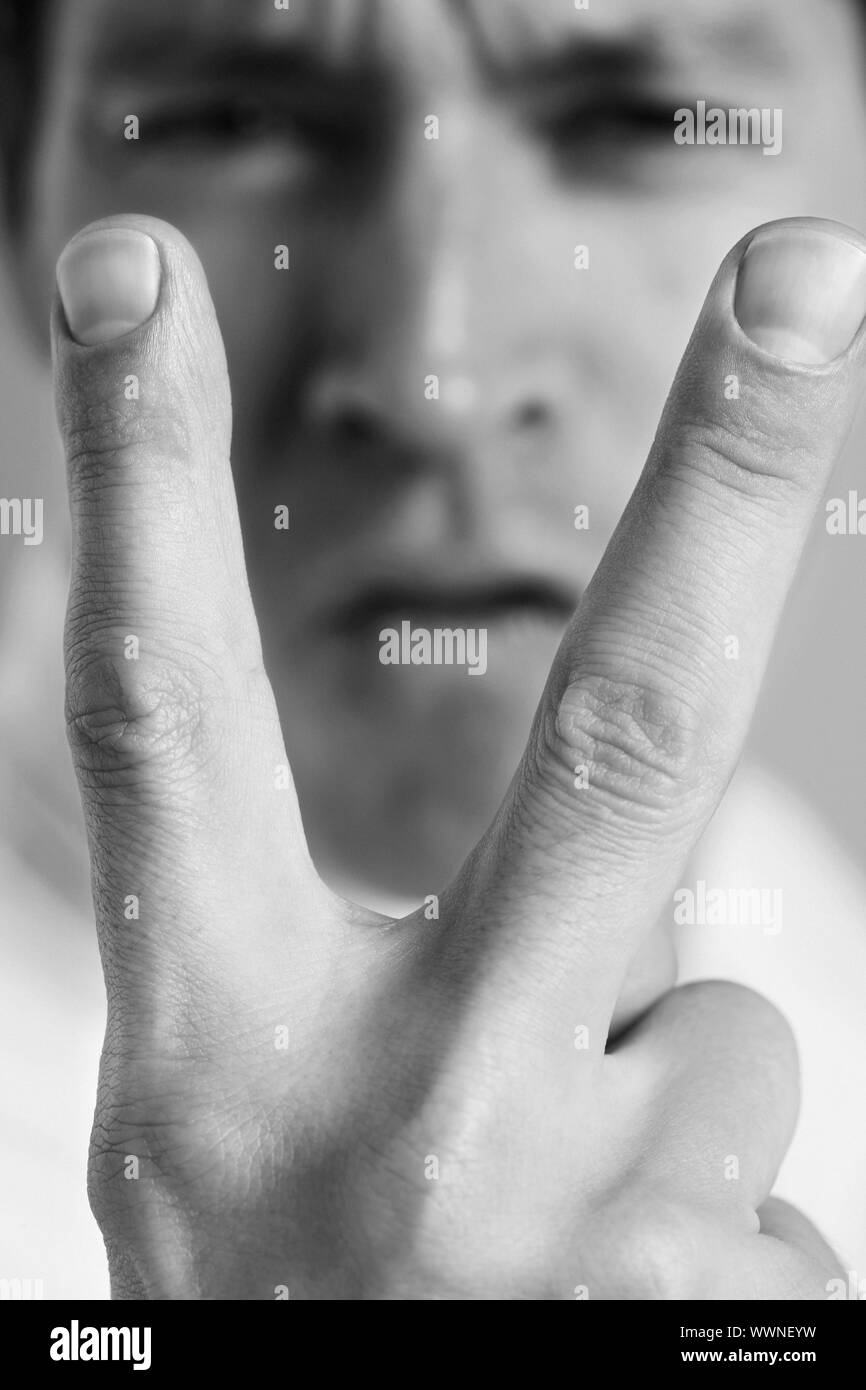 Man Giving the Peace Sign Stock Photo