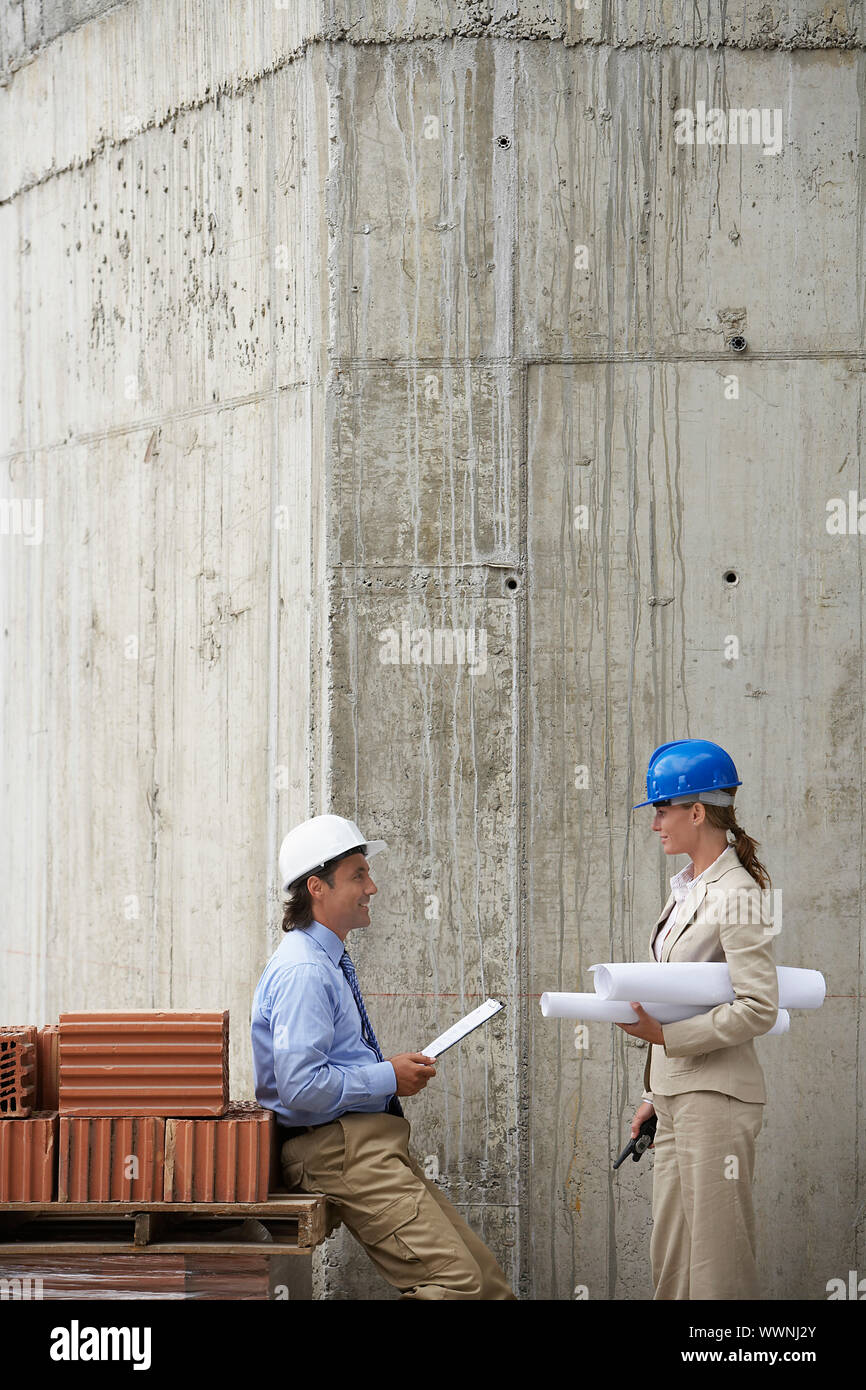 Businesspeople Looking at Blueprint Stock Photo