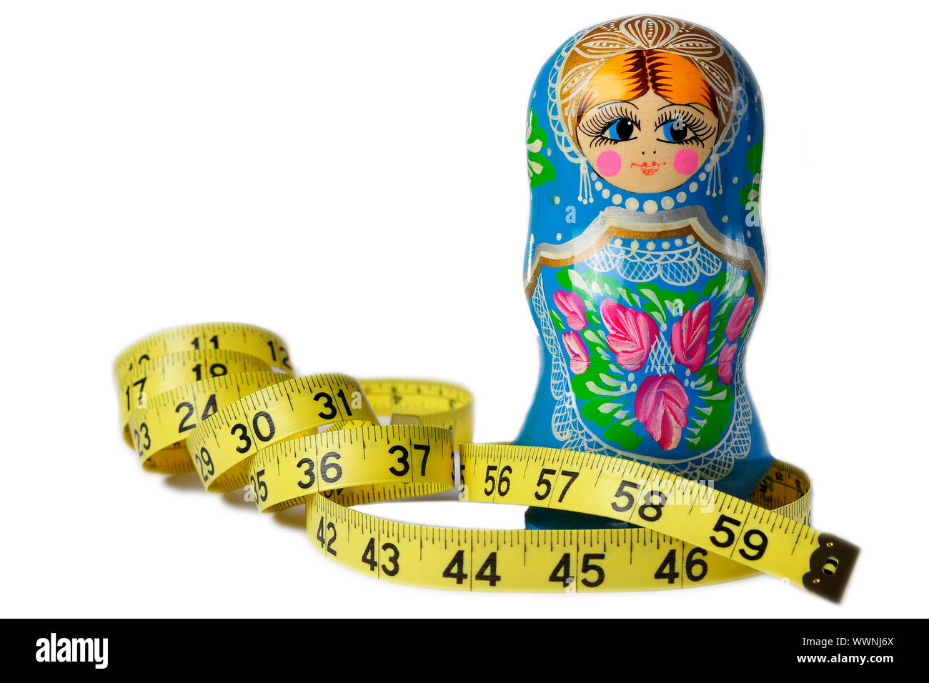 A thin Matrioska doll with a measuring tape around its waist Stock Photo