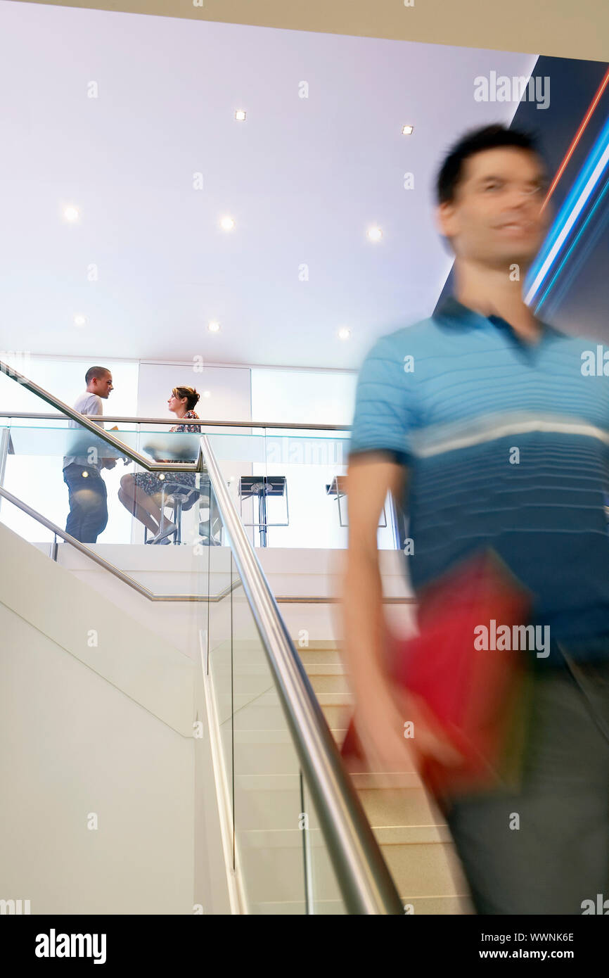 Businessman Walking Down Stairs Stock Photo