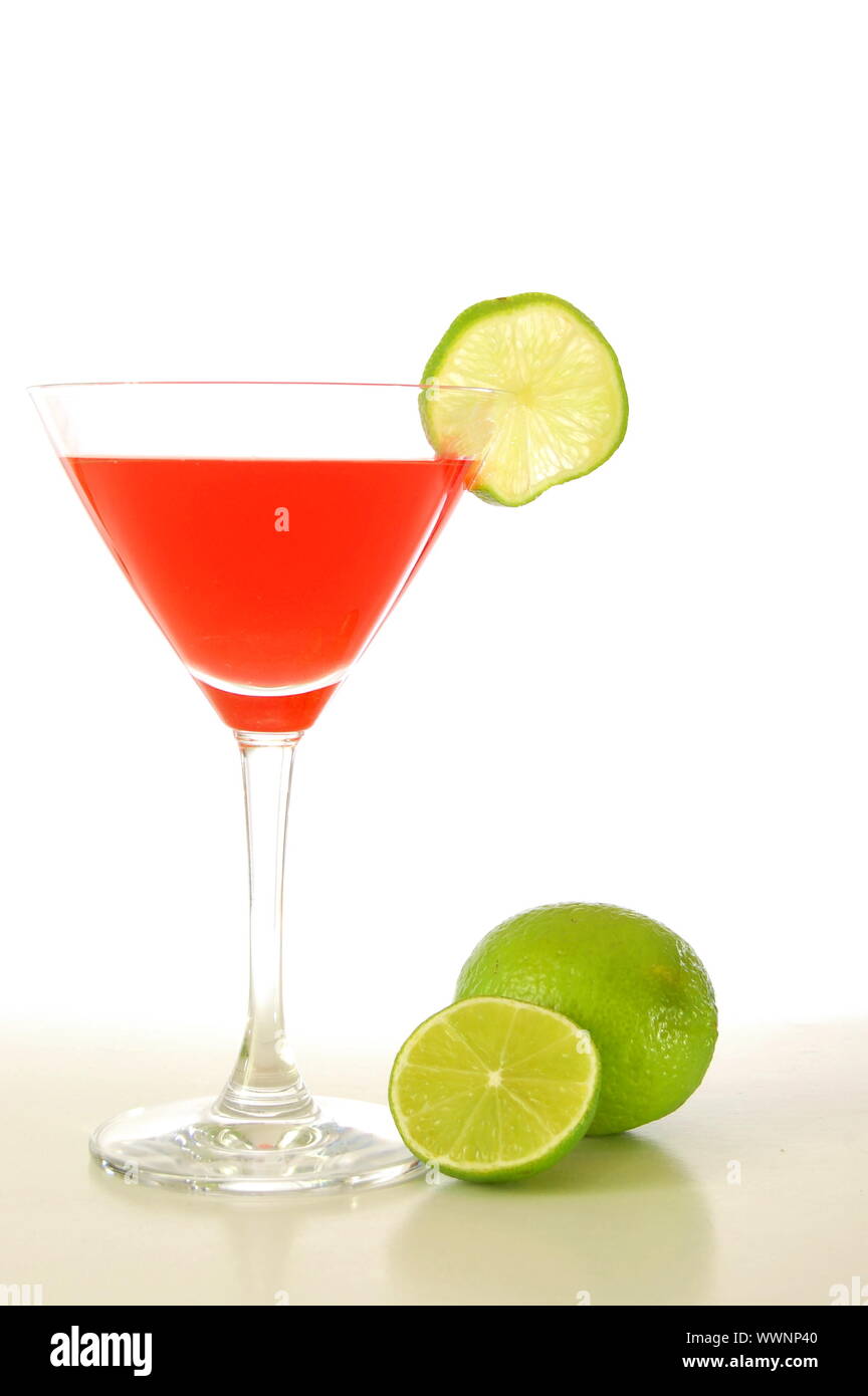 red and cold alcoholic drink with green lime Stock Photo - Alamy