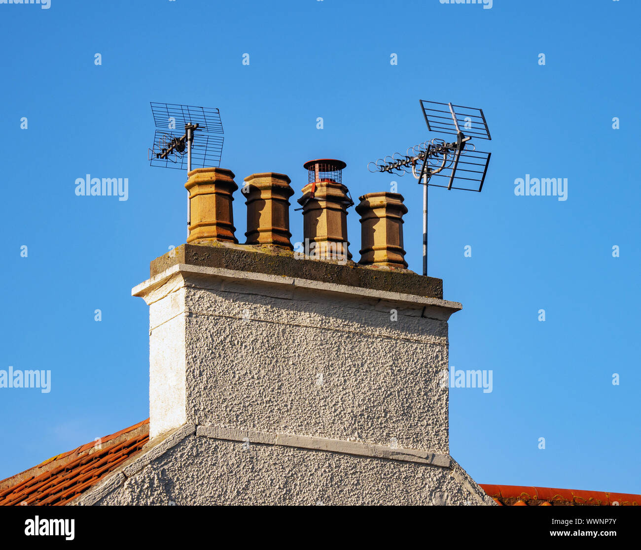 Multiple Chimney Pots with television aerials. Stock Photo
