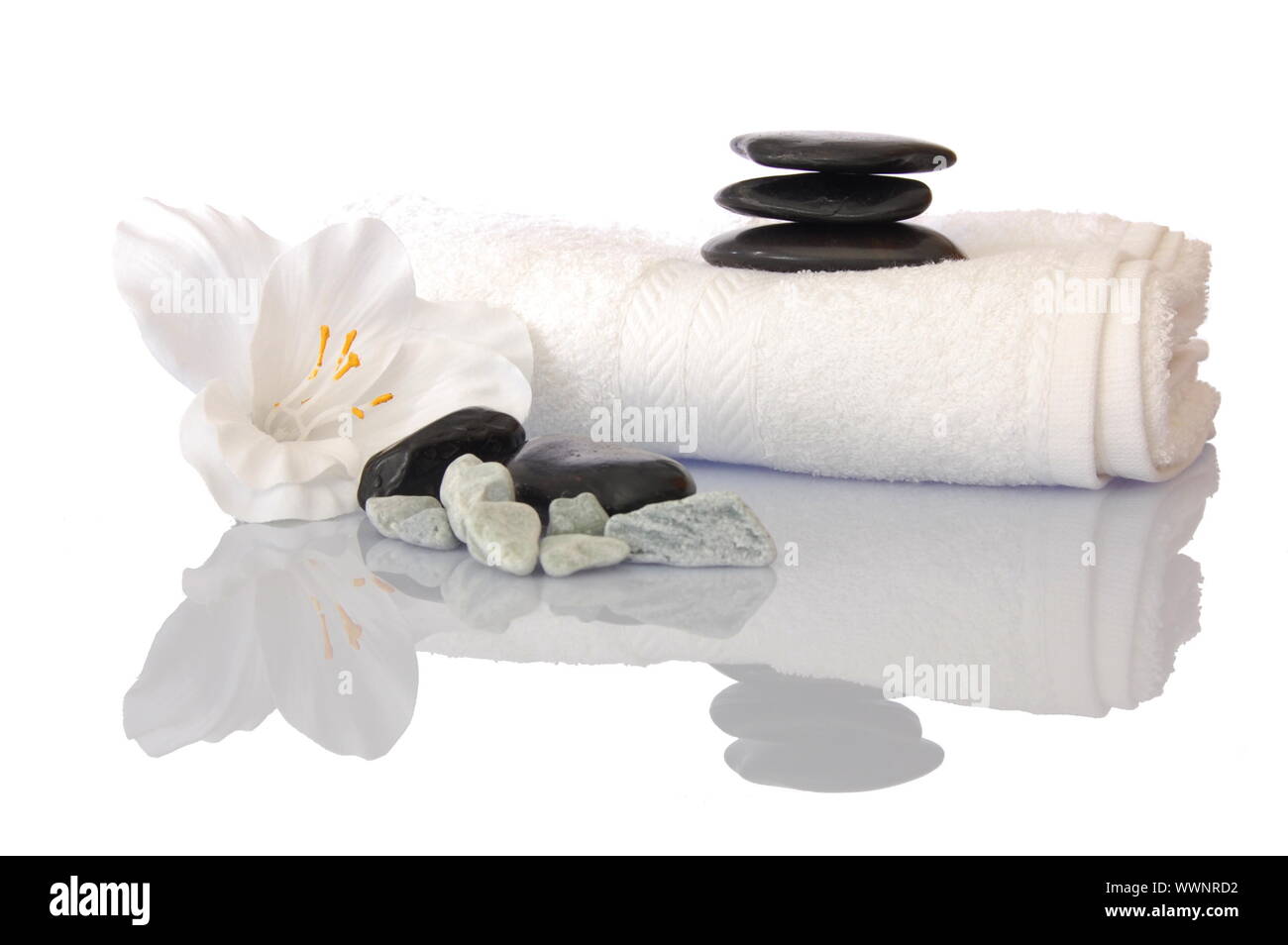 wellness zen and spa still life with flower towel and pebbles isolated on white Stock Photo