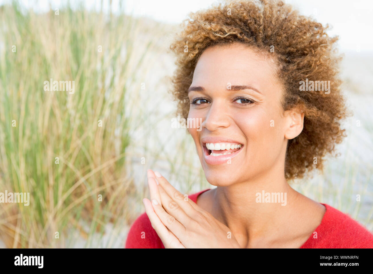 Young woman relaxing at beach looking at camera Stock Photo - Alamy