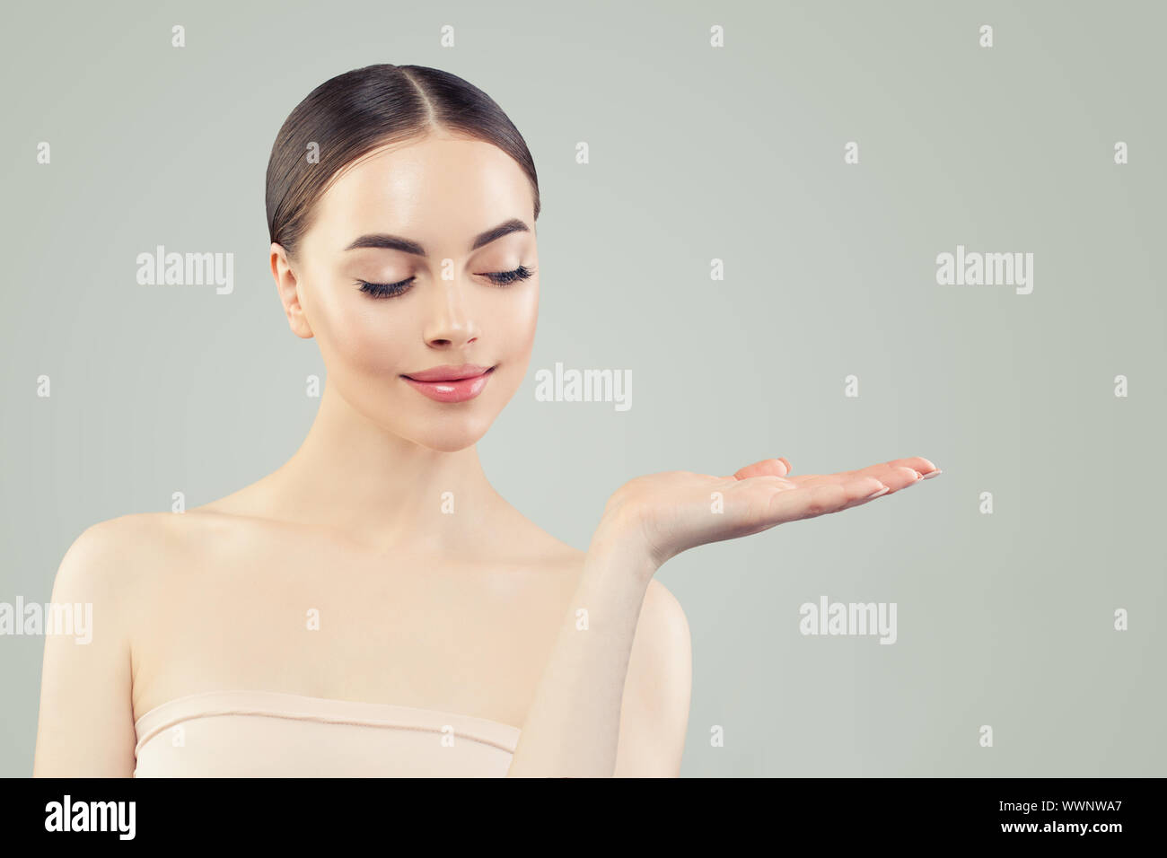 Cute woman showing empty copy space on open hand Stock Photo - Alamy