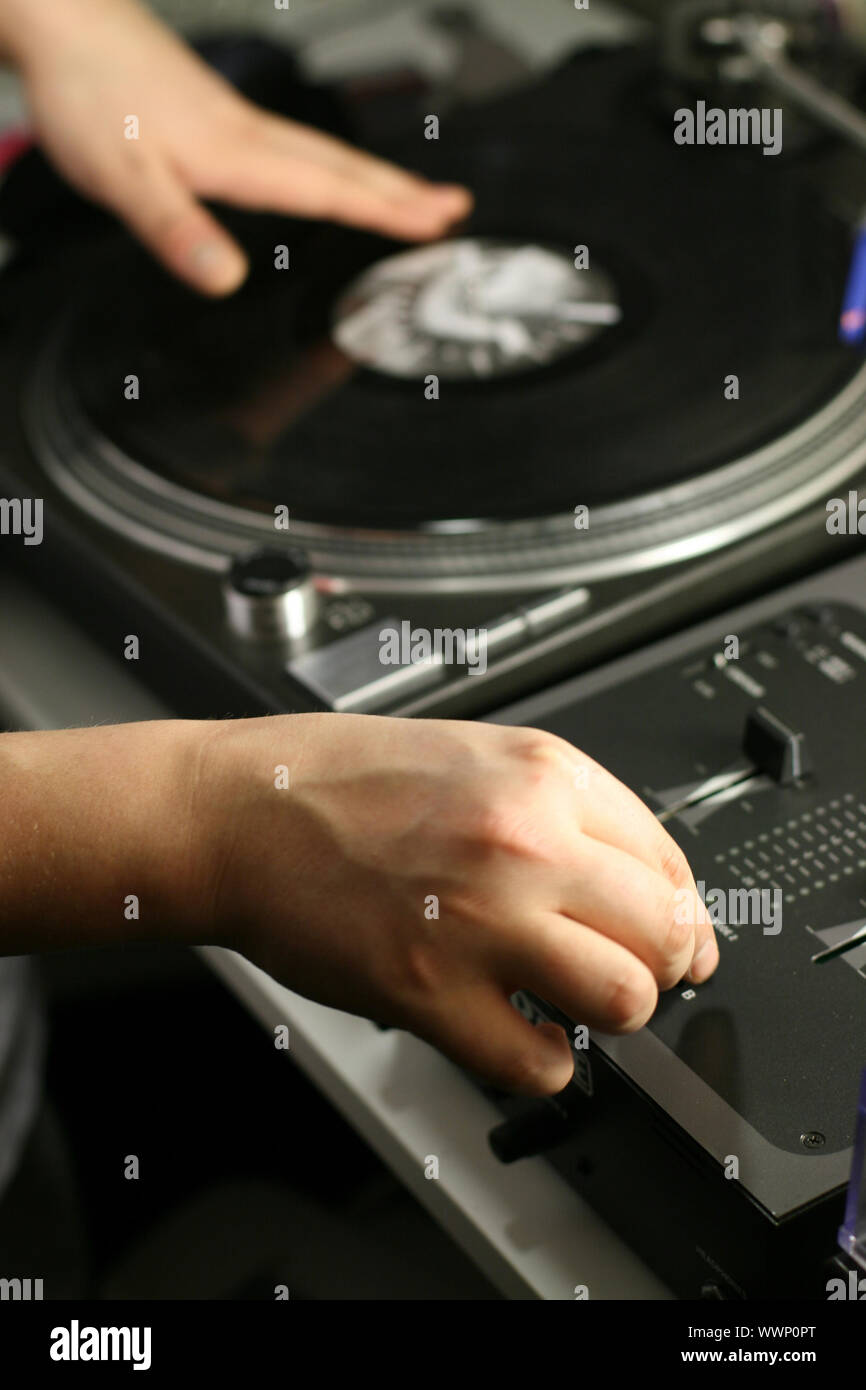 scratch battle of dj playing on his vinyls hand on Stock Photo Alamy