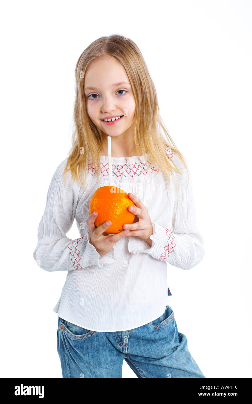 Portrait of happy little girl drinking orange juice. Isolated over ...