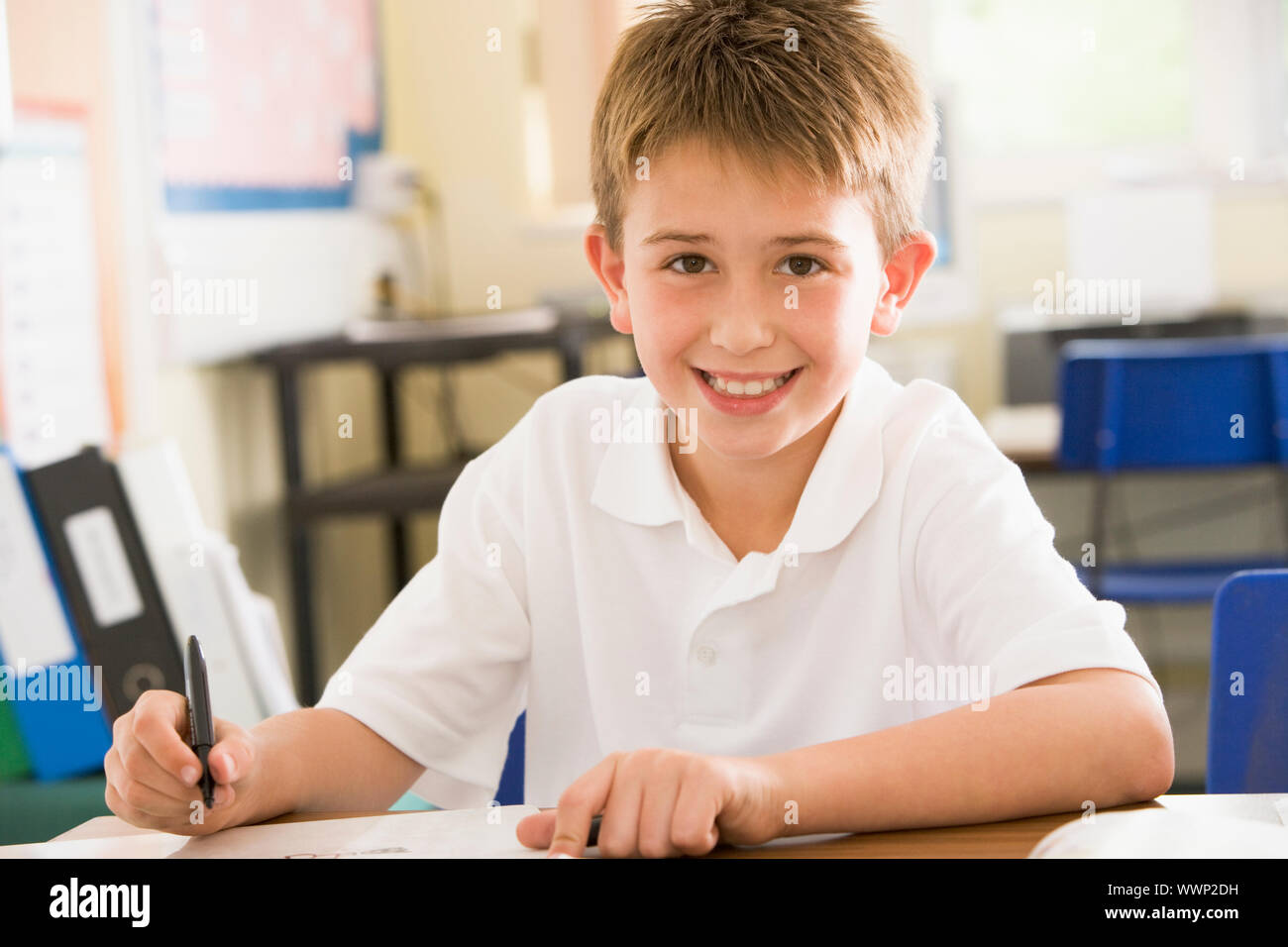 Student in class taking notes Stock Photo