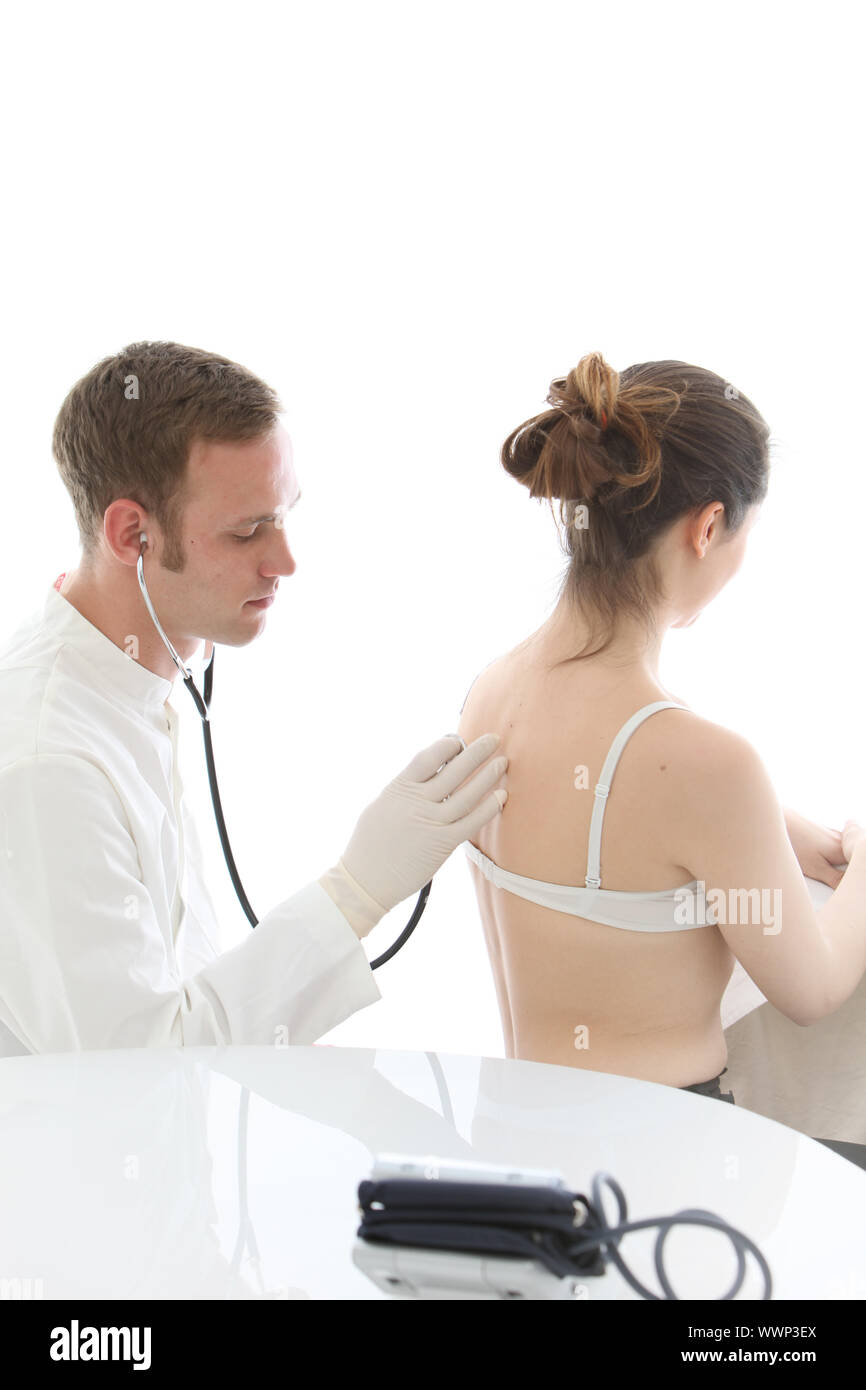 Doctor listening to a woman's lungs and breathing with a stethoscope during  an examination Stock Photo - Alamy