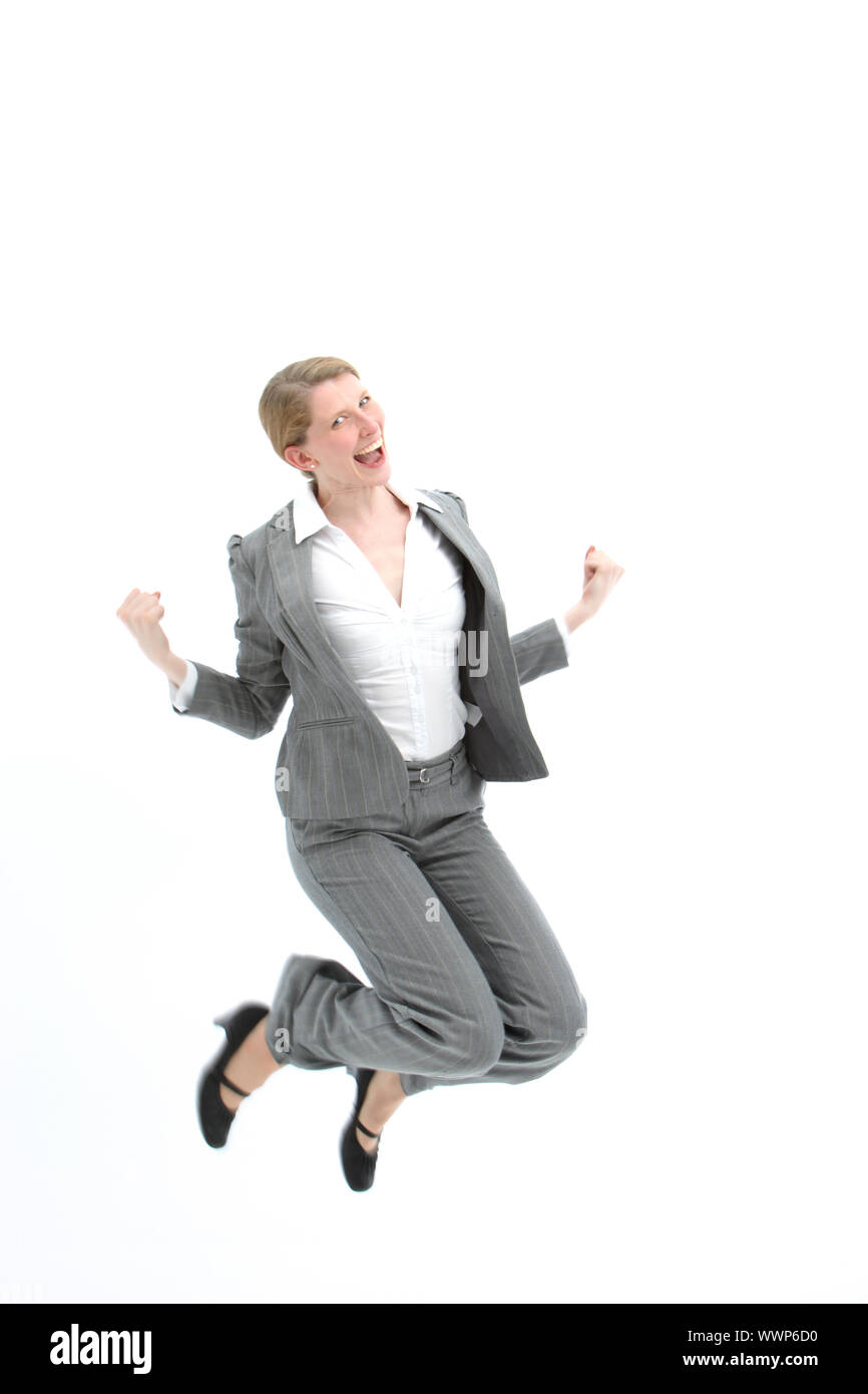 Successful woman jumping for joy with both feet raised and her fists