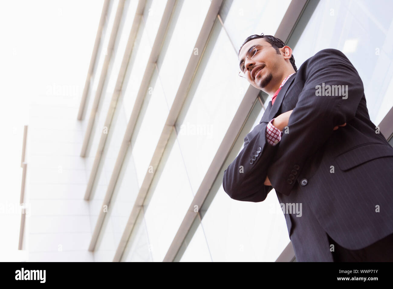 Man In Building Businessman standing outside modern office building Stock Photo - Alamy