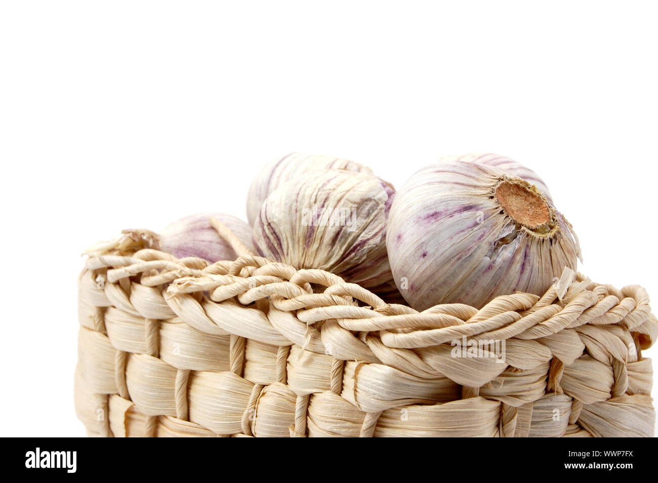 garlic in a basket isolated on white background Stock Photo - Alamy