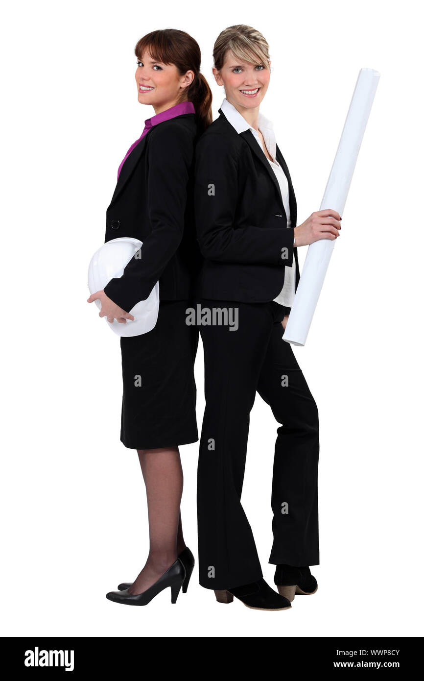 Two female architects standing back to back Stock Photo