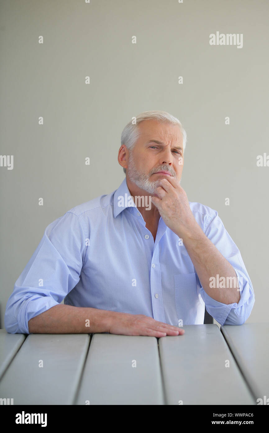 senior male stroking his beard Stock Photo Alamy
