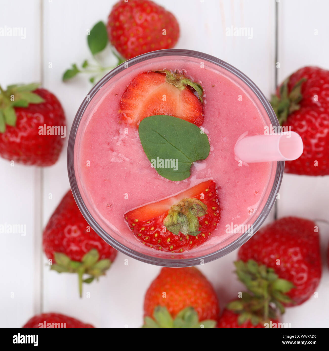 Strawberry smoothie juice milkshake with fresh strawberries fruit juice from above Stock Photo