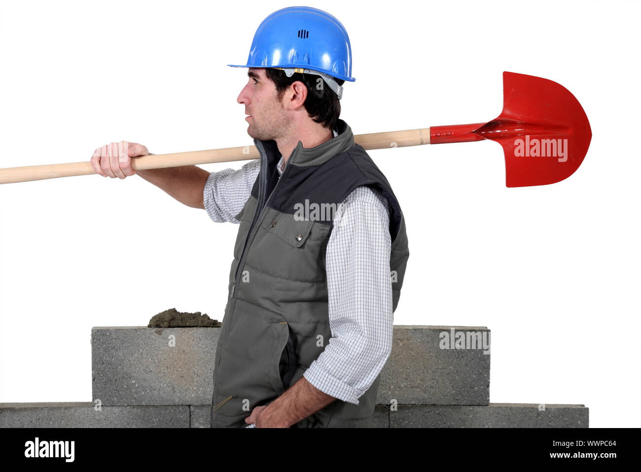 craftsman carrying a shovel on his shoulder Stock Photo Alamy