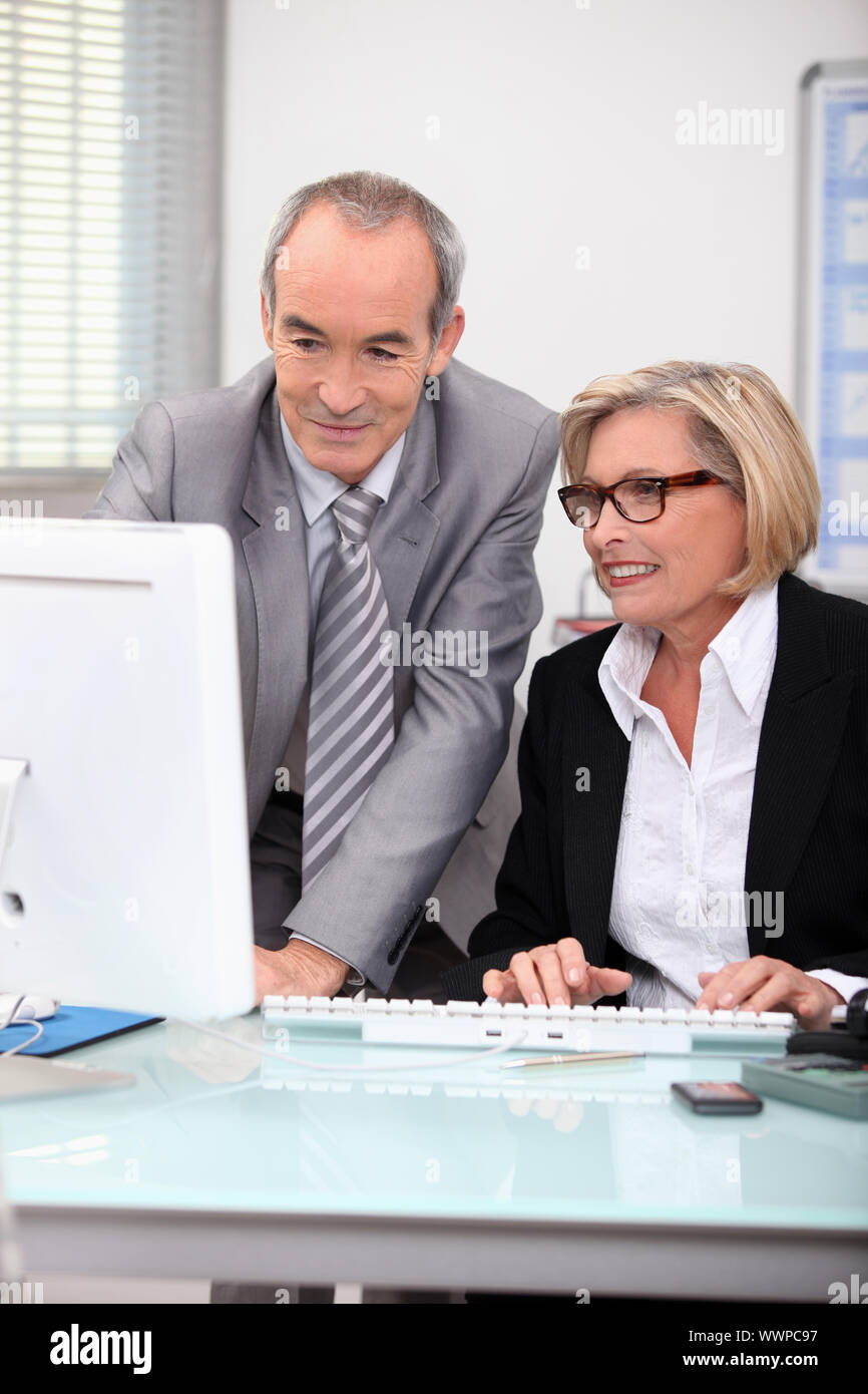 Senior businesspeople in front of laptop computer Stock Photo